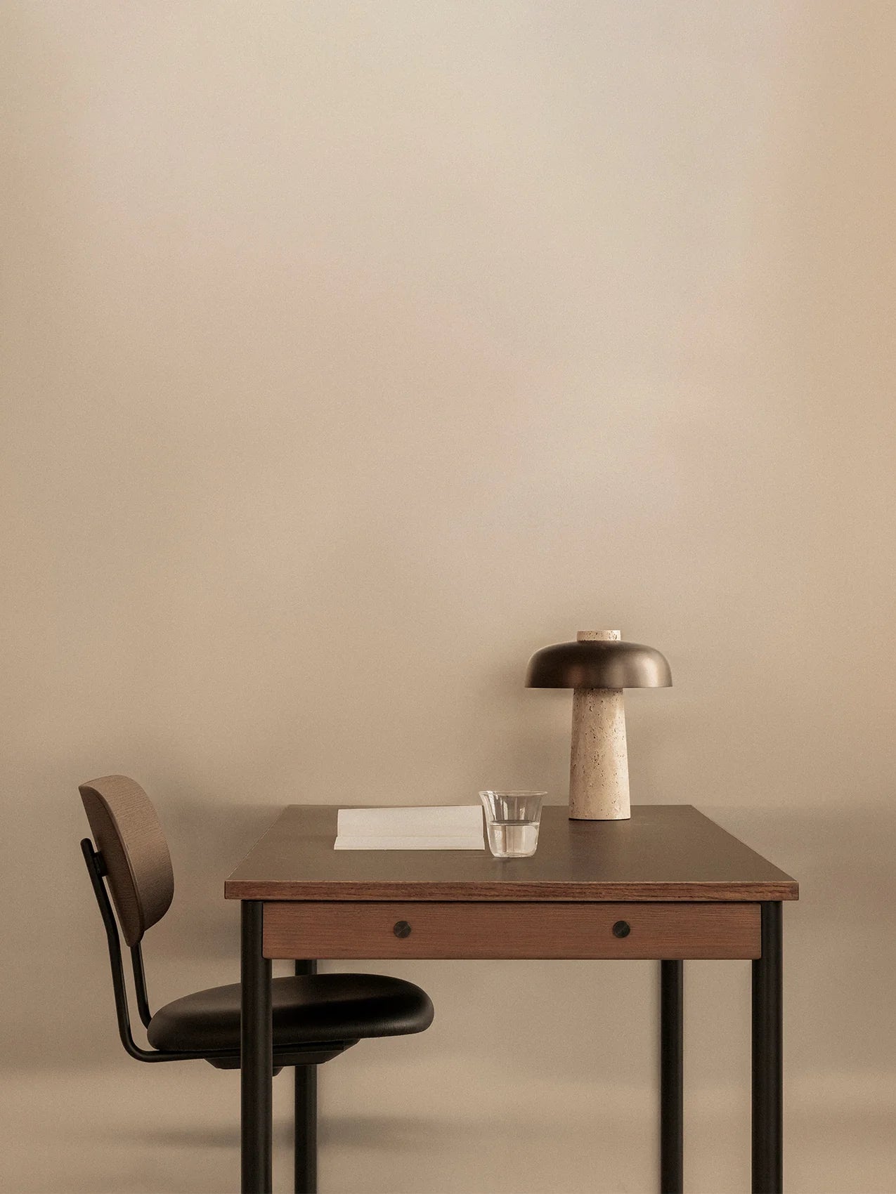 Co Task Chair Dark Stained Oak with Sierra 1001, Seat Upholstered with Black Frama by Audo Copenhagen at a desk with an table lamp from Audo Copenhagen.