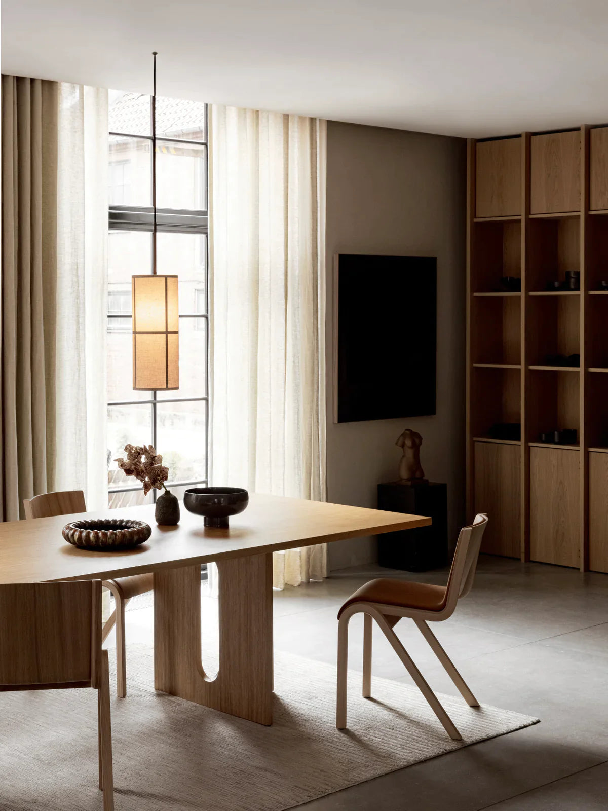 Hashira Pendant Lamp by Menu hanging in a light and architectural interior.