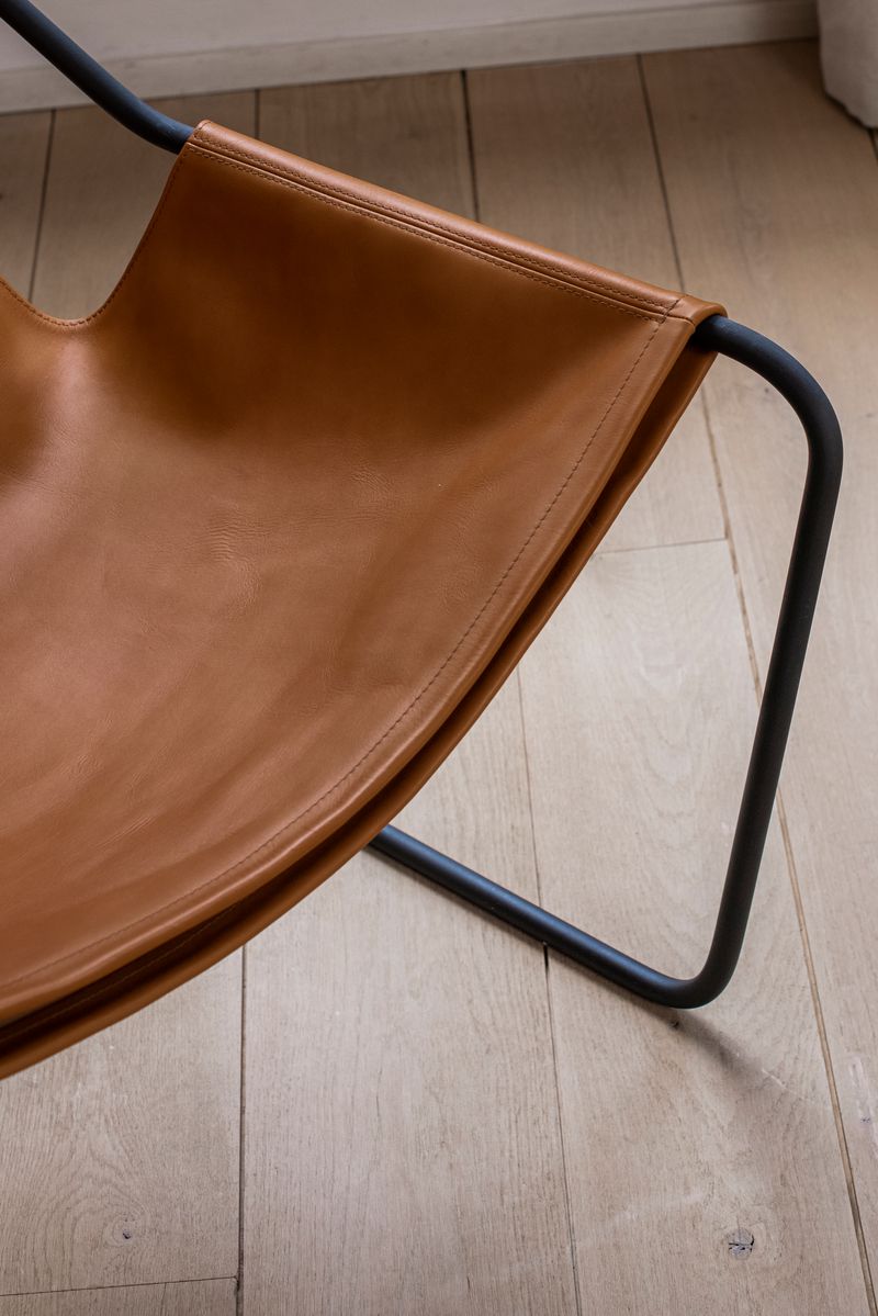 Details of the Paulistano Chair by Objekto. Made with a Phosphate Black Frame and Whisky leather seating.