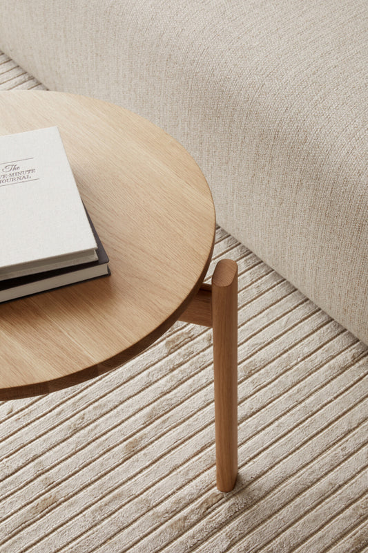 A close up of the Passage Lounge Table Naturel Oak from Audo Copenhagen with two books.