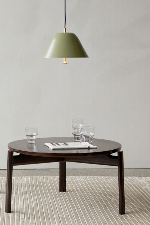 The Passage Lounge Table Lacquered Oak from Audo Copenhagen with glasses of water and a green lamp