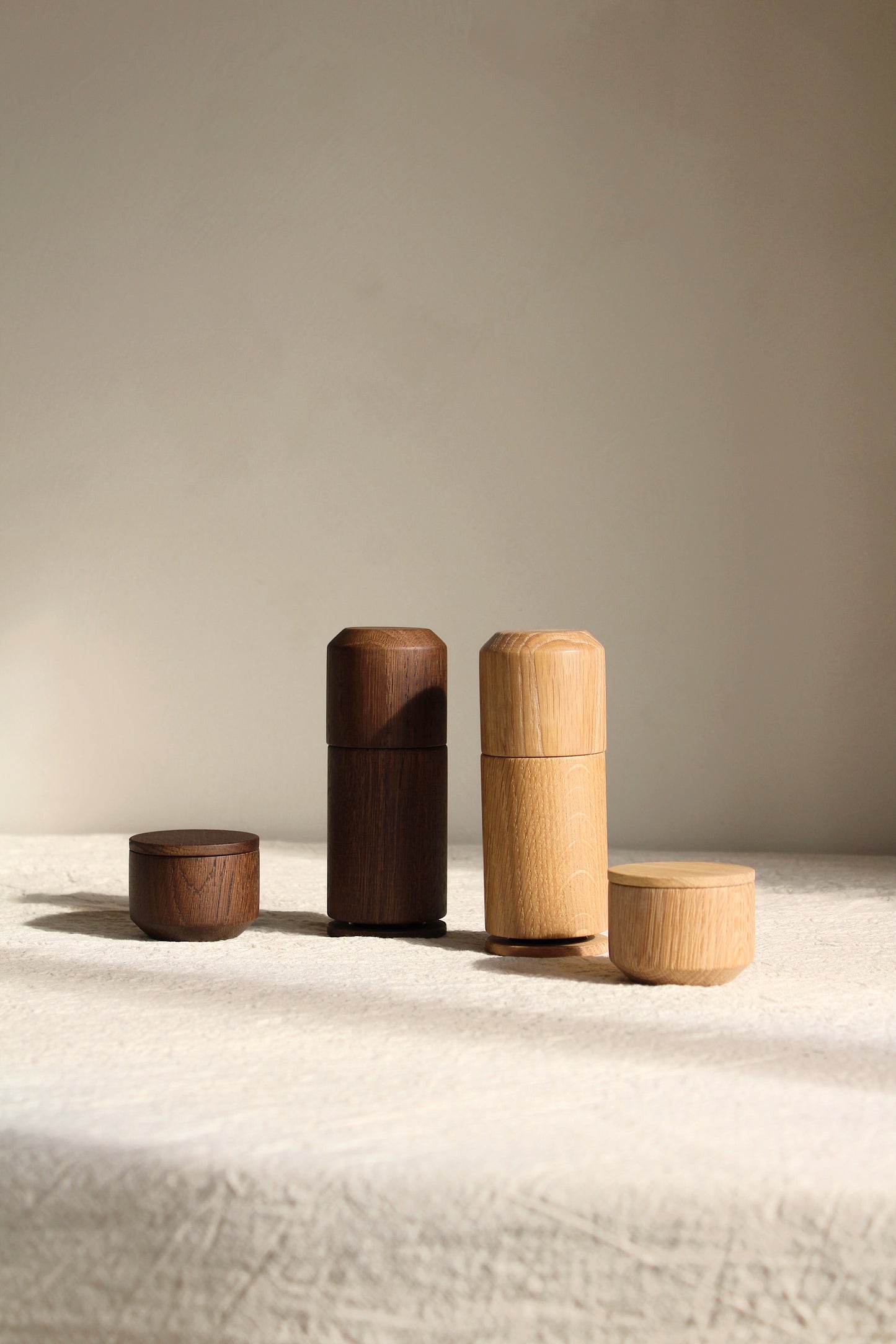 EKTA Living Crush Me - Pepper grinder and salt jar - natural oak & smoked oak set on neutral linen table cloth