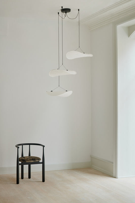 Tense Lamp Chandelier Ø55 New Works, interior setting  with chair.