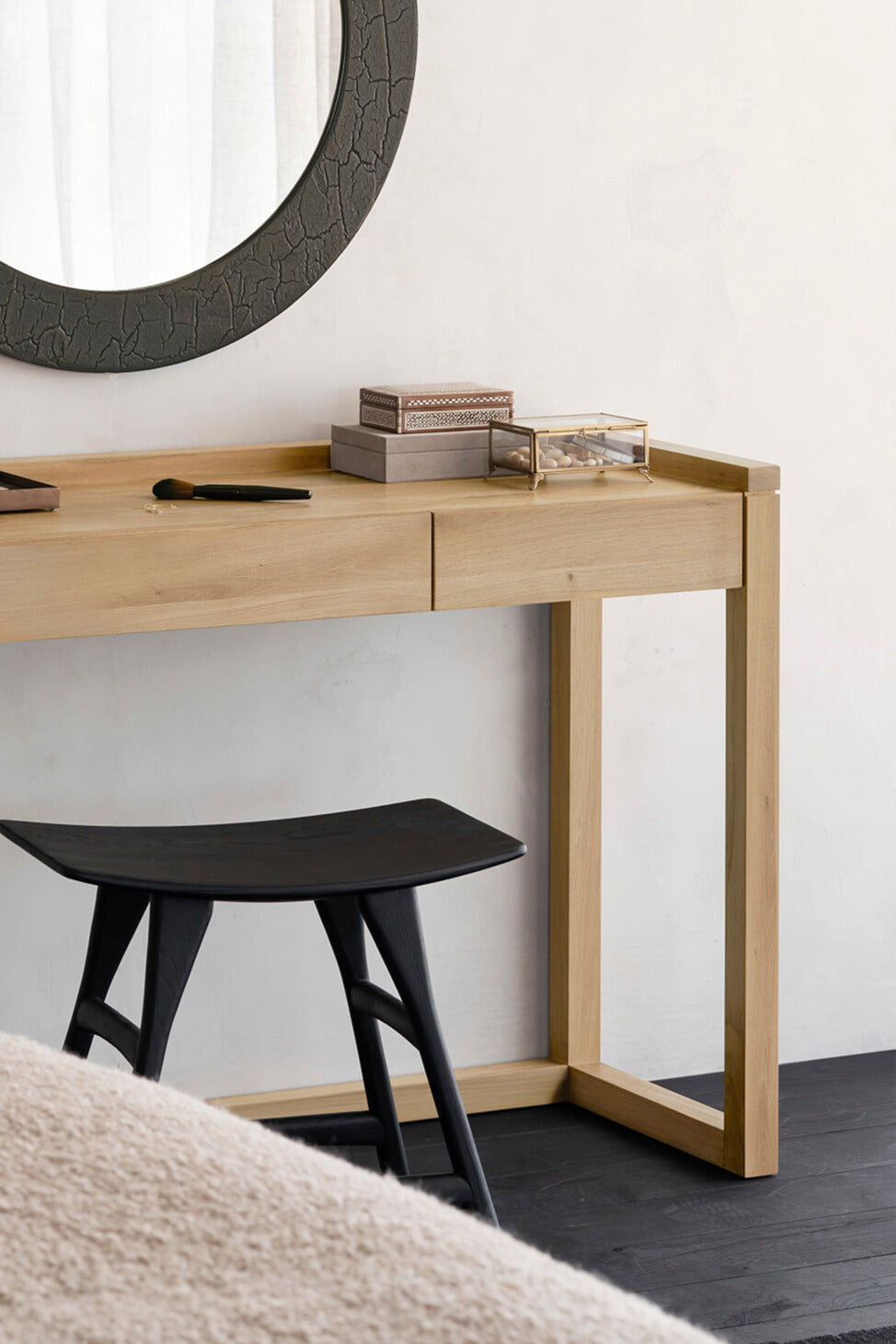 The Frame Desk from Ethnicraft with a black stool and a mirror above
