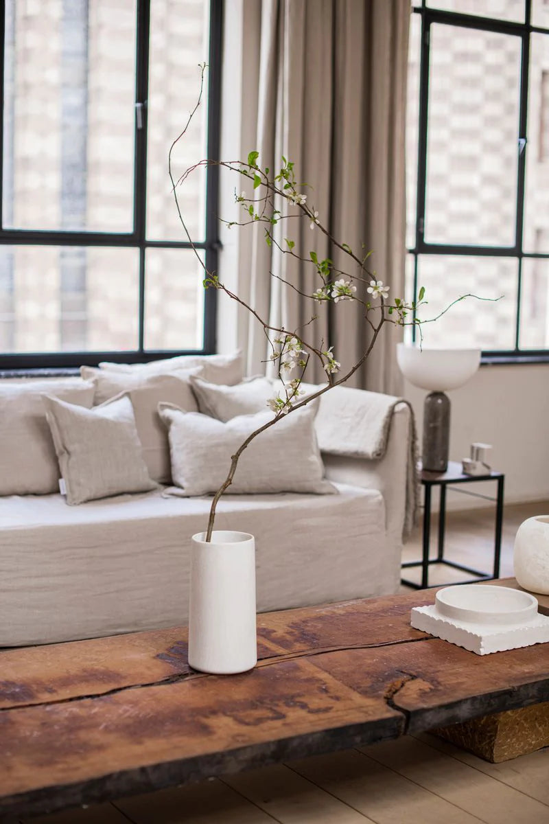 Vases set in a light and lofty interior living room space at Enter The Loft