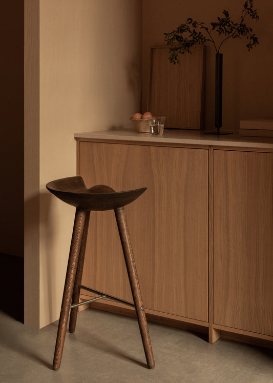 The ML42 Bar Stool in the corner of a kitchen. This is the Brown Oiled Oak color.