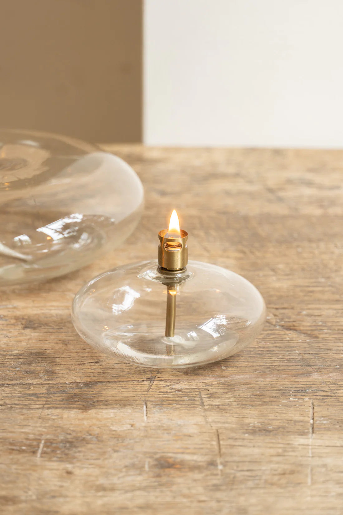 oval glass oil lamp on wood table detail photo