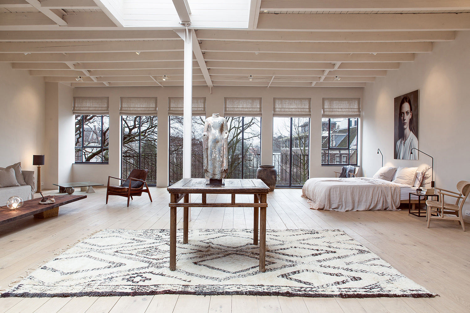Enter The Loft IV Edition - a lofty living room filled with design furniture and lots of windows