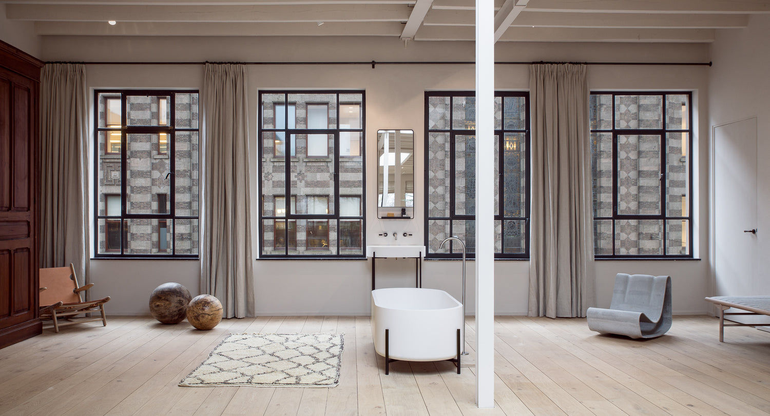Enter The Loft IV Edition - a light lofty space with design furniture, lots of windows and a calm neutral aesthetic