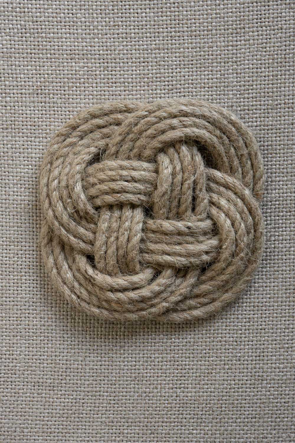 Bonni Bonne Small Coaster - Braided trivet on neutral textile background