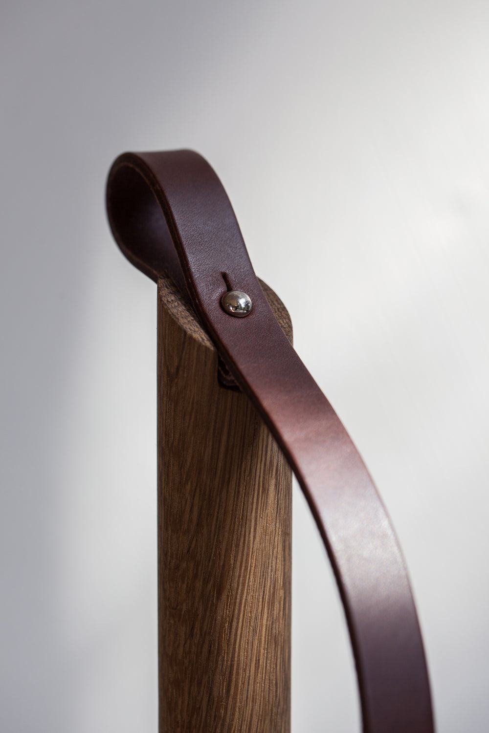 Smoked oak wood and dark leather strap details of the Paper-Towel Holder by EKTA Living