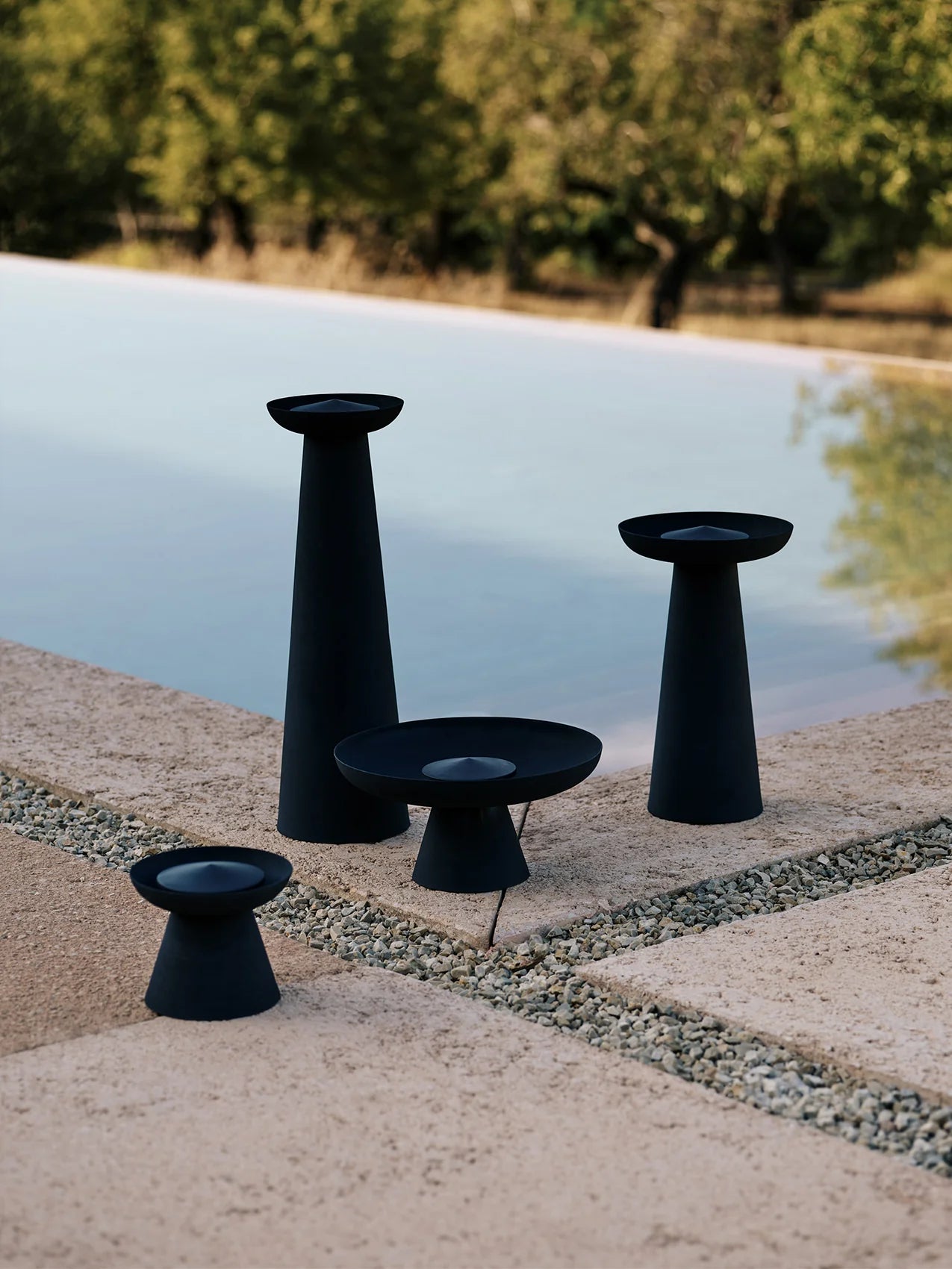 Meira oil lanterns by Audo Copenhagen next to pool