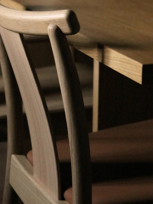 A close up of the Merkur Dining Chair in Natural Oak from Audo Copenhagen