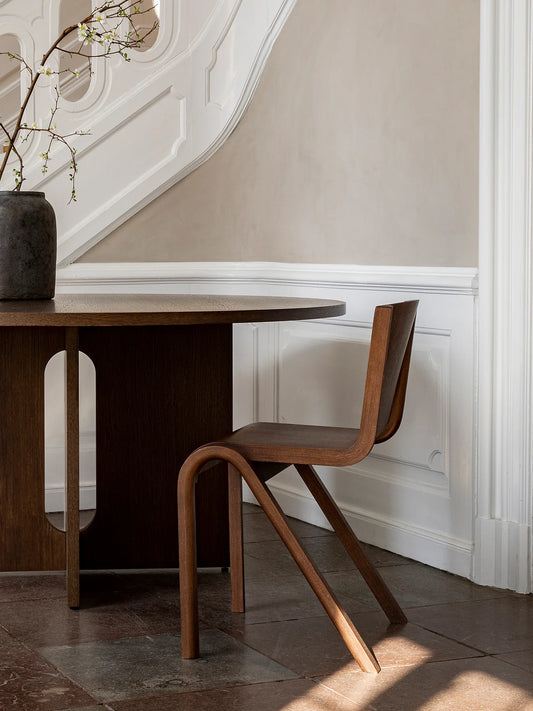The Red Stained Oak Ready Dining Chair Without Upholstery by Audo Copenhagen in a hallway. 