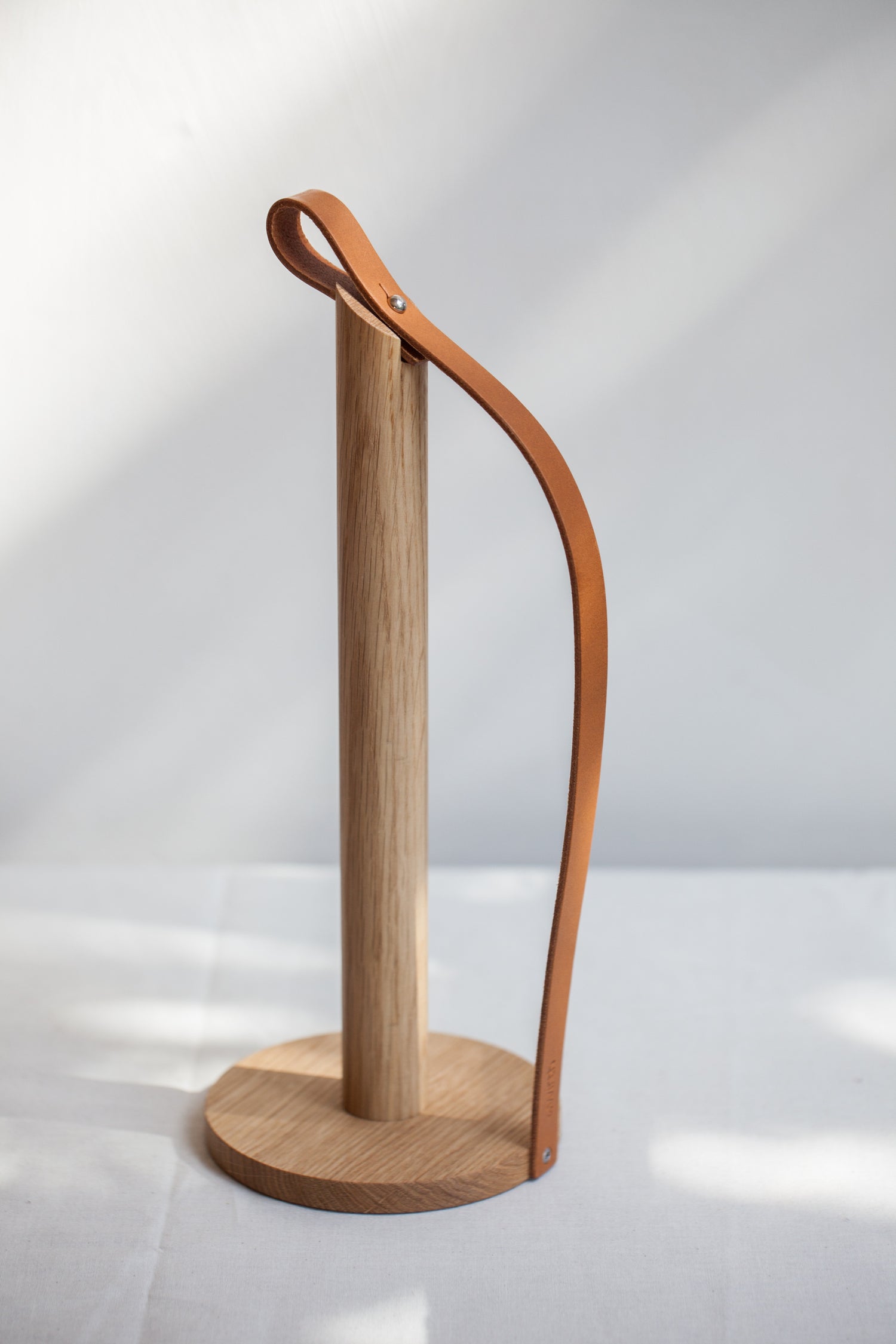 Paper-Towel Holder made from oiled oak with leather strap by EKTA Living.