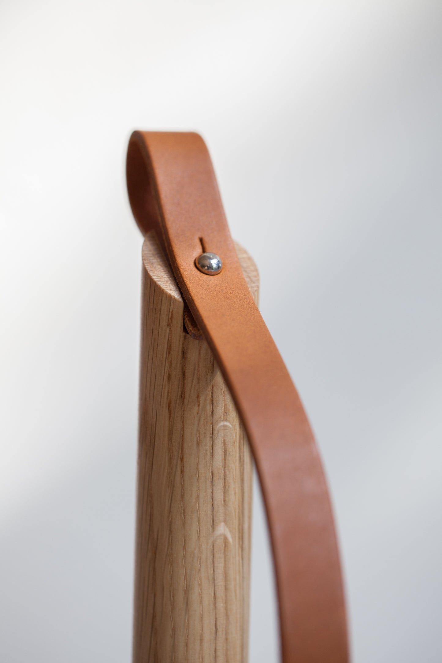 Oiled oak wood and leather strap details of the Paper-Towel Holder by EKTA Living