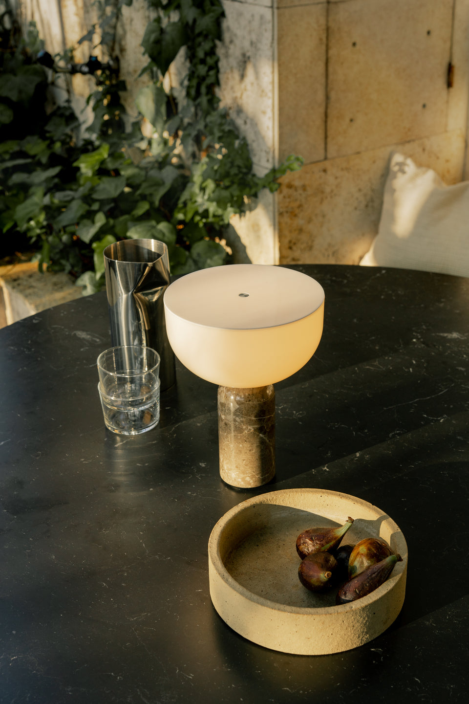 new works kizu table lamp portable with gris du marais marble on table setting outside