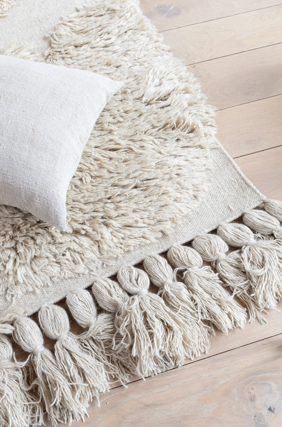 The beautiful Handwoven Rug No. 7 by Capellen Dimyr has different textures combined and big tassels.