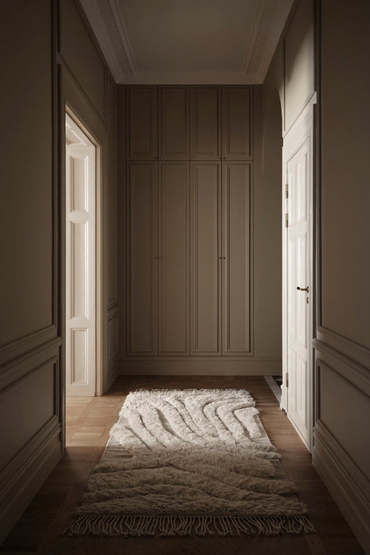 Minimalist interior featuring the handwoven rug tapestry as a statement piece. Adds texture and visual interest to the room.