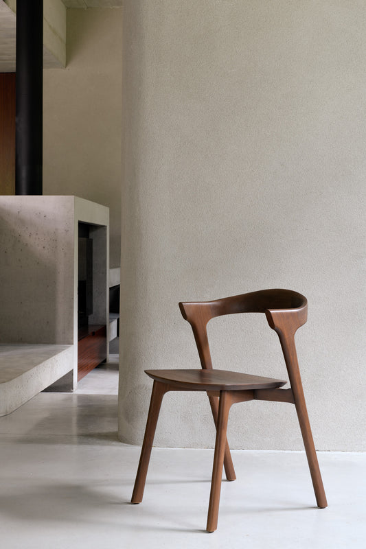 bok dining chair teak brown against grey wall