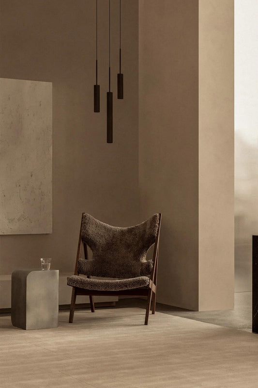 The Tubulaire Pendant Canopy 3 above the Knitting Chair with the Volume Side Table from Audo Copenhagen.