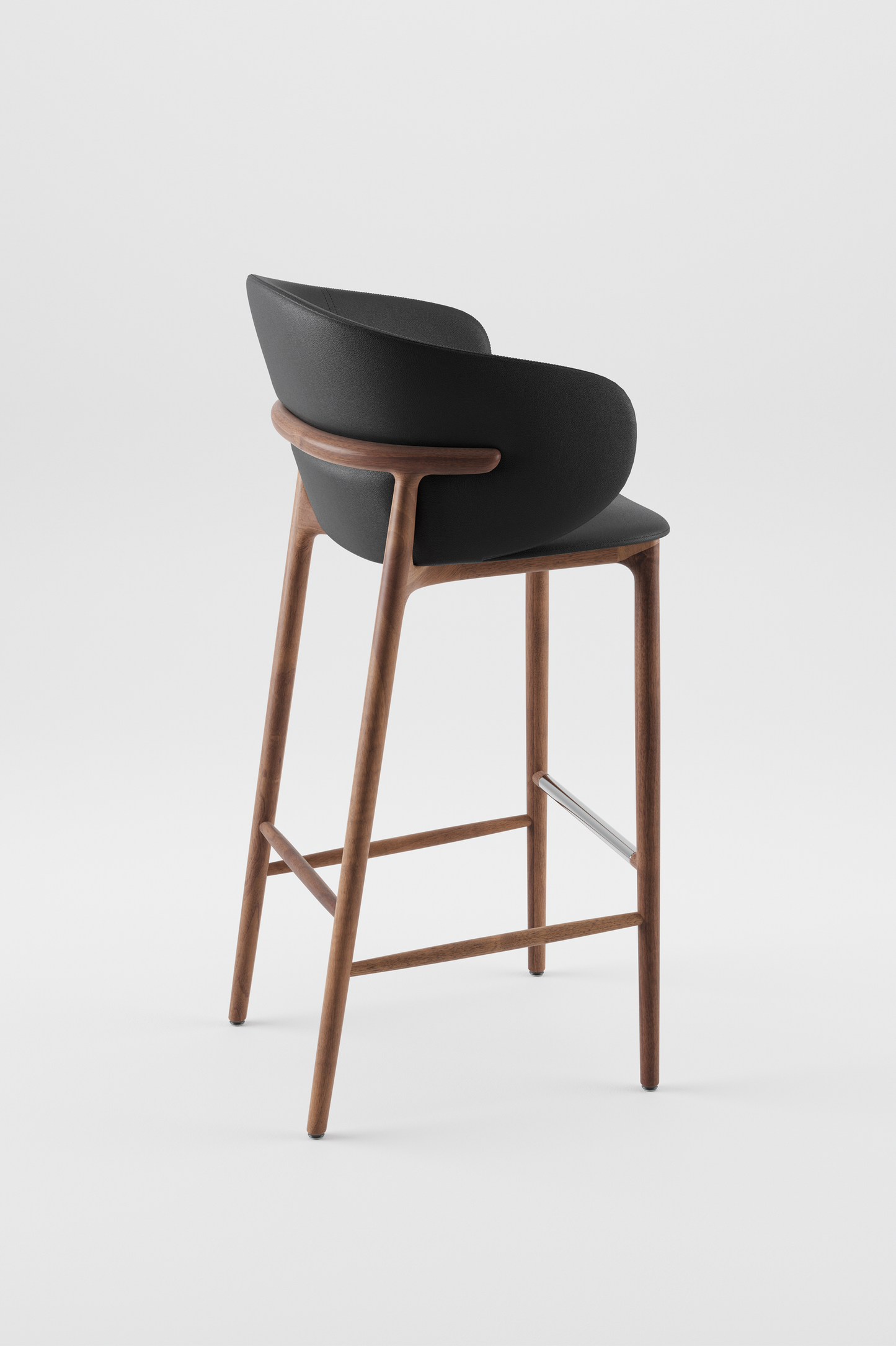 The Mela Bar Chair from Artisan. American Walnut and stainless steel footrest