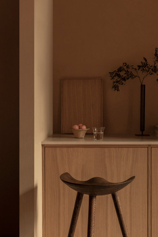 The ML42 Bar Stool in the corner of a kitchen. This is the Brown Oiled Oak color.