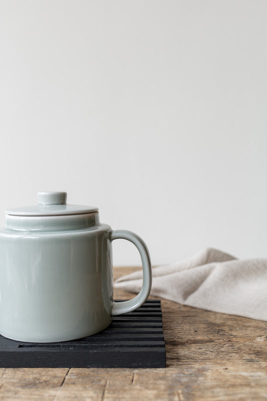 detail shot of black table frame with teapot