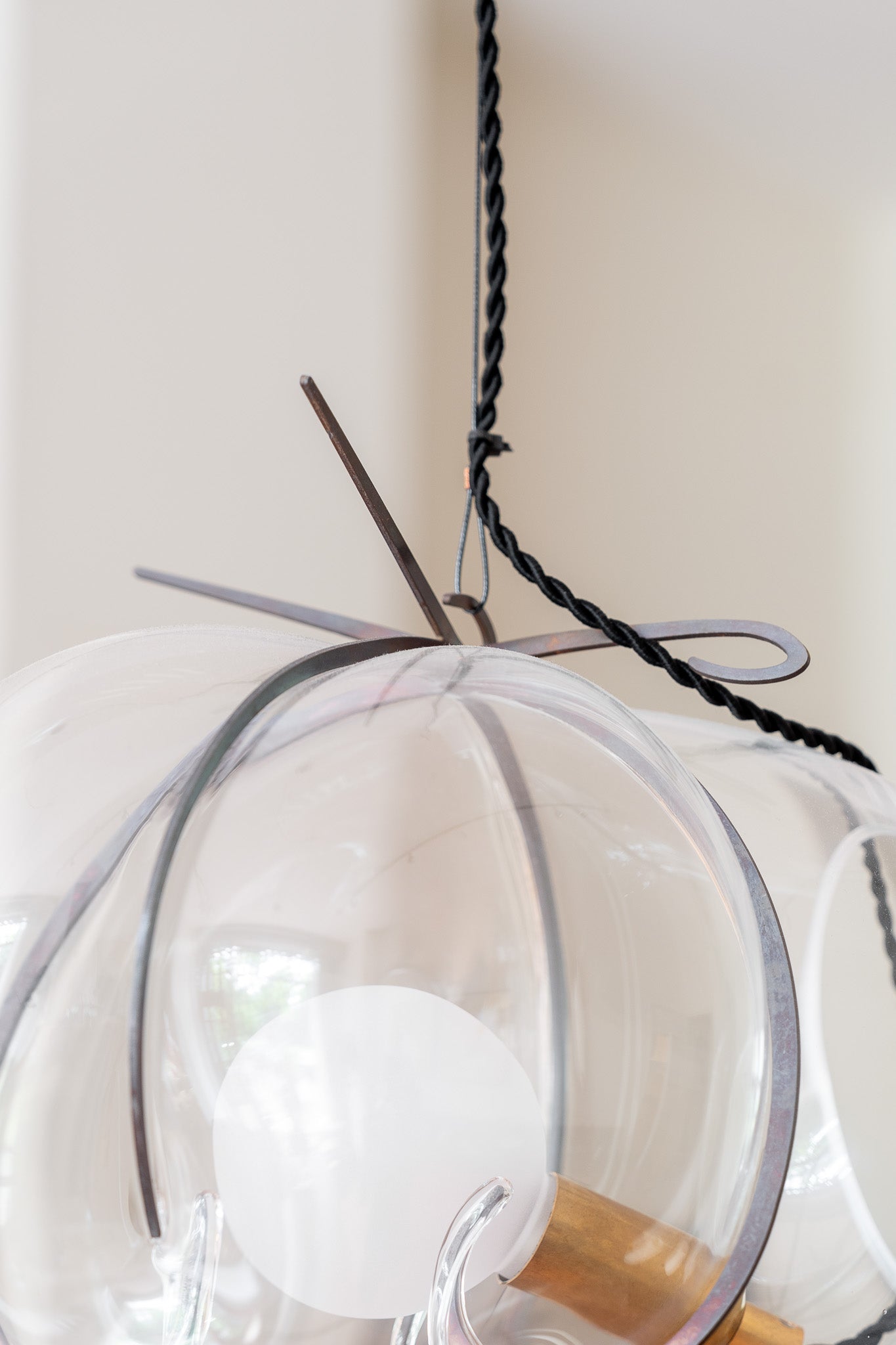 Exhale Pendant Lamp by WDSTCK. A hanging glass bubble with metal frame detail photo.