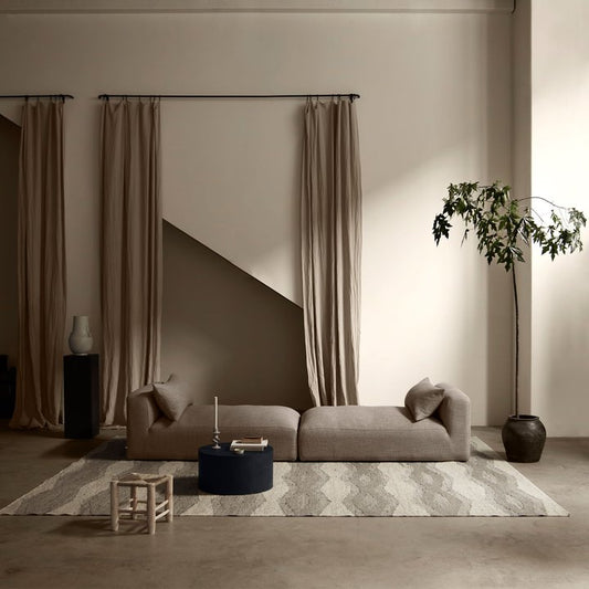 Sofa module long with two daybeds in taupe colored interior setting with old elements 
