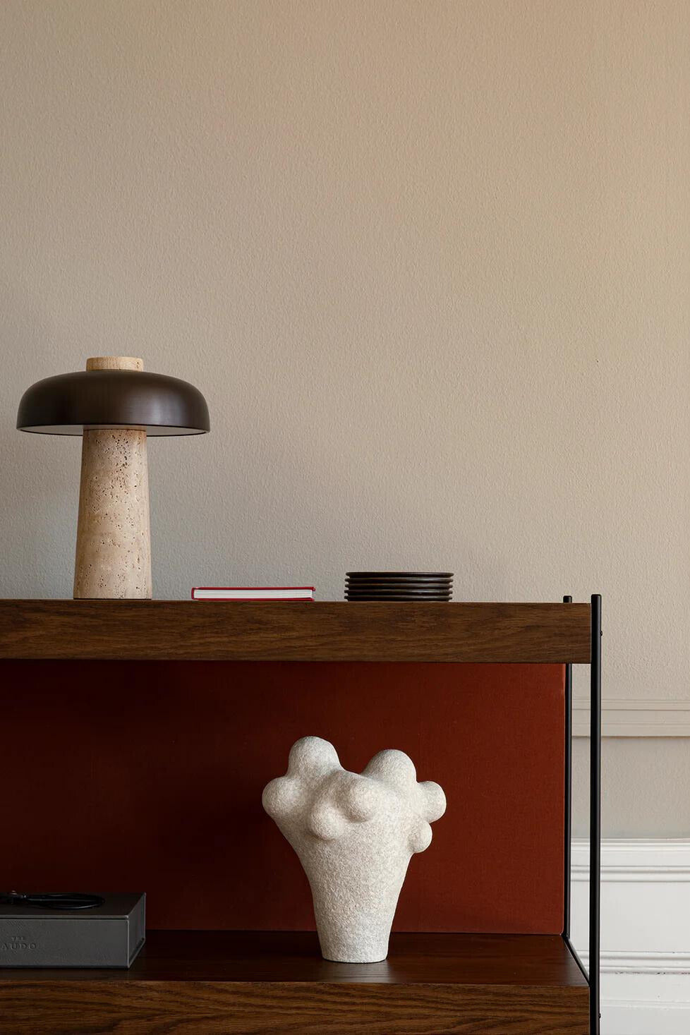 The Reverse Table Lamp from Audo Copenhagen on a cabinet.