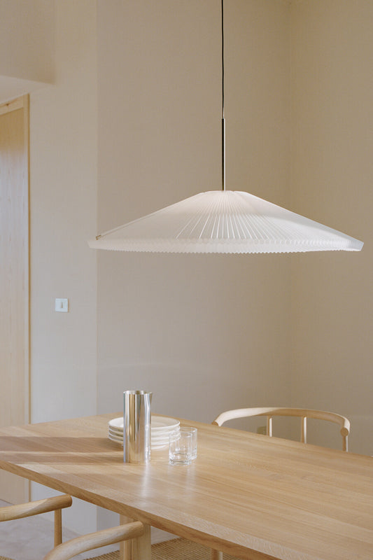 Nebra Pendant Lamp Large by New Works above wooden dining table