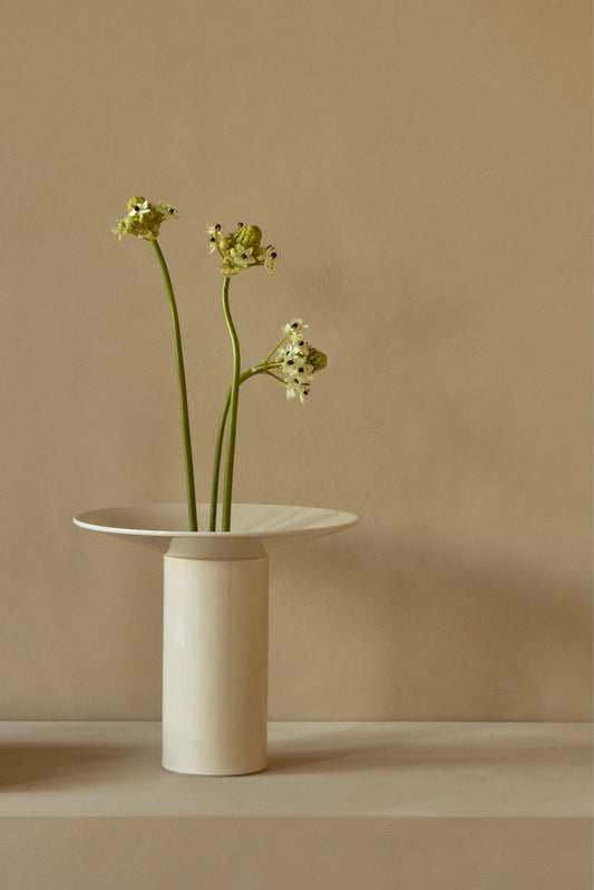 Audo Copenhagen (Menu) Ashen Hana Vase with three green flowers against beige wall