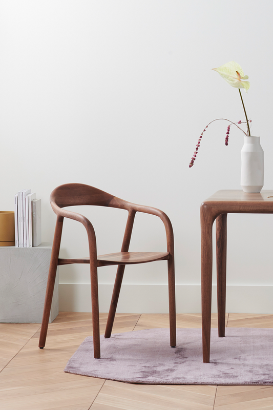 The Lakri Dining Table in Walnut by Artisan together with the Neva Chair in Walnut