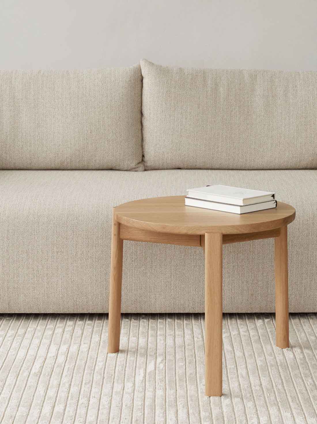 Side view of the Passage Lounge Table Natural Oak with 2 books on top