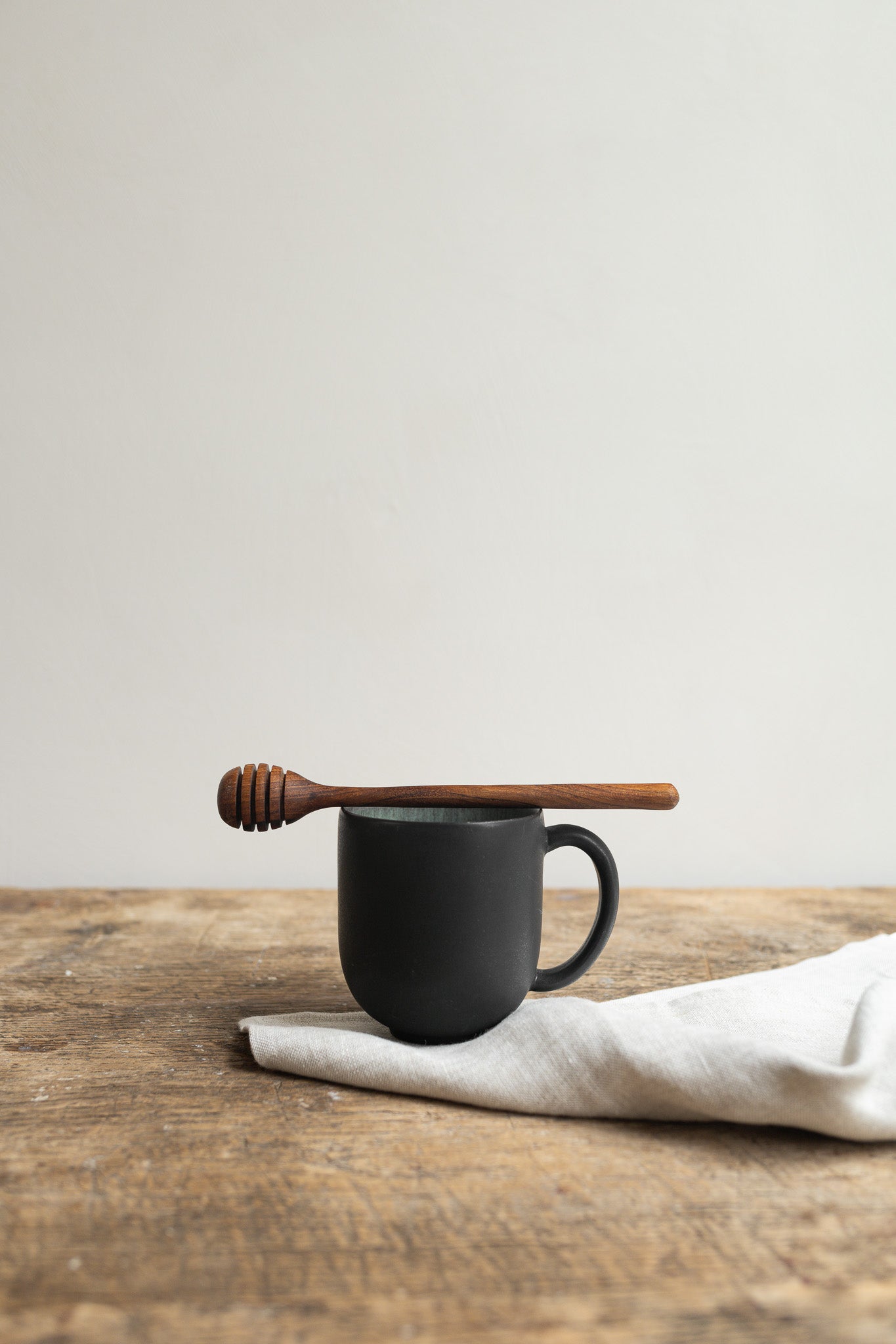 wooden honey spoon by original home in setting with mug and napkin