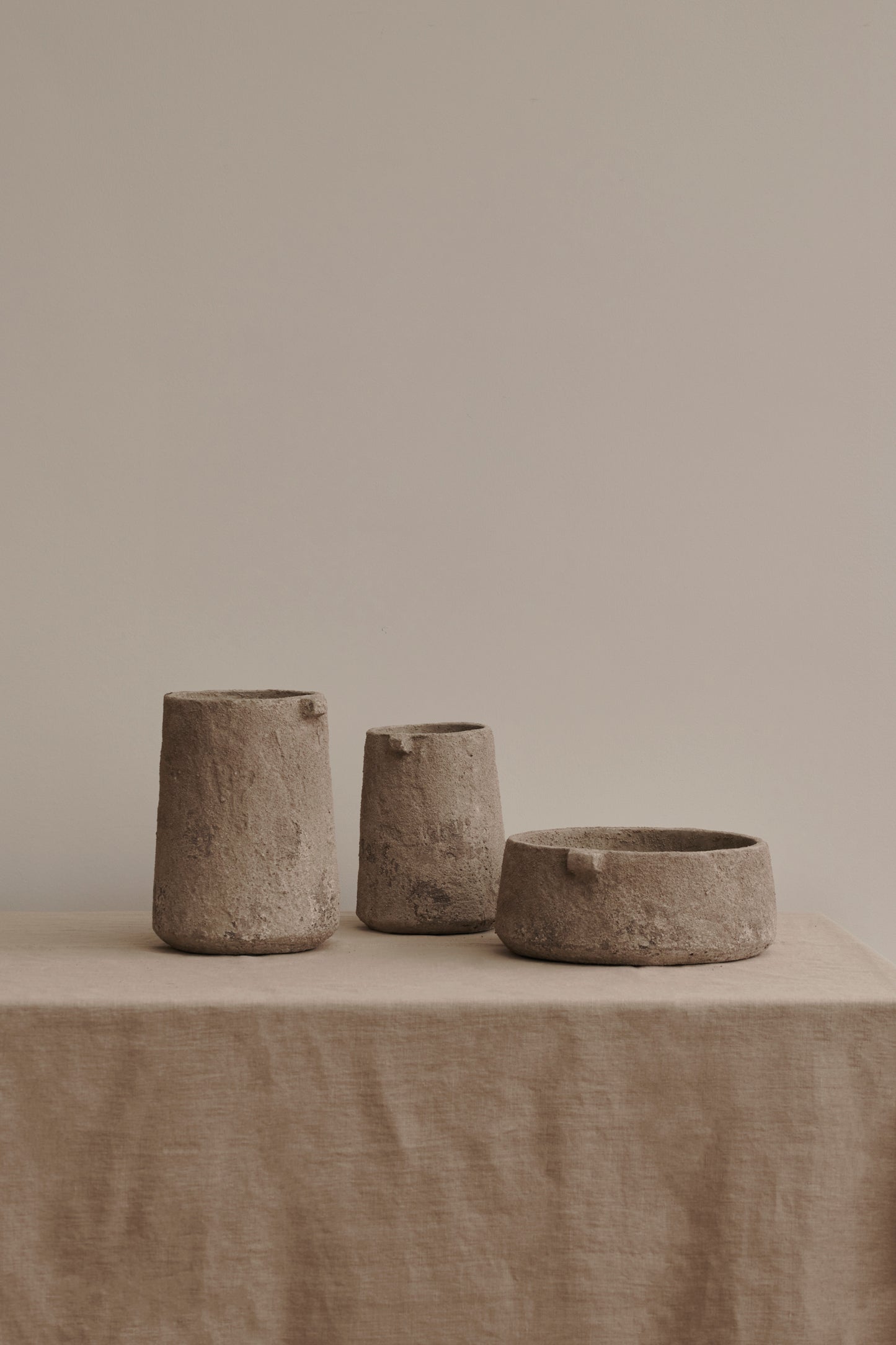 Earthenware Gaia Bowl and Vase by Serax set on table with linen cloth.