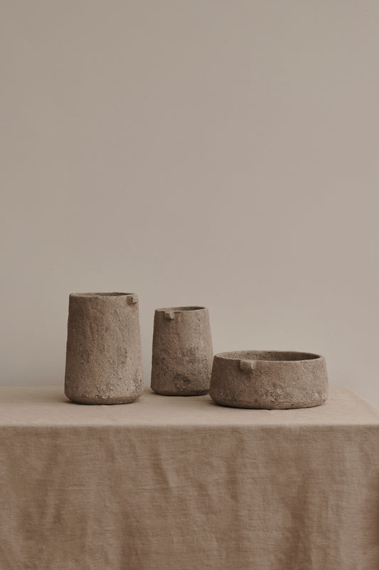 Gaia Vase and Bowl by Serax made from earthenware, set on table with linen cloth.