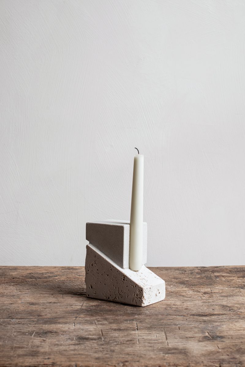 Offset Candleholder by Kristina Dam with a candle.