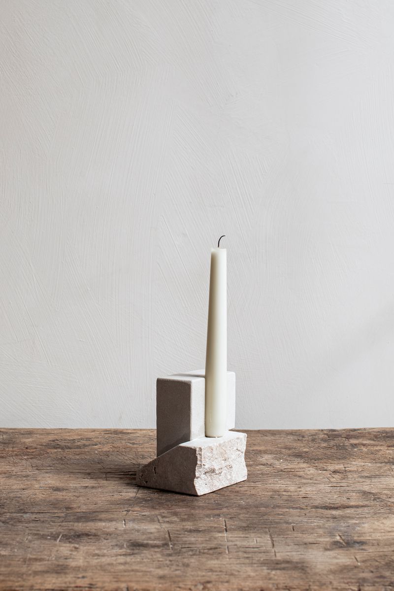 Offset Candleholder by Kristina Dam with a candle.