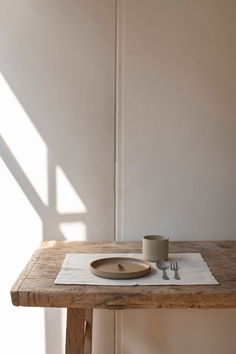 Timeless Linen Placemat set on wooden table set with plate, mug and cutlery at Enter The Loft.