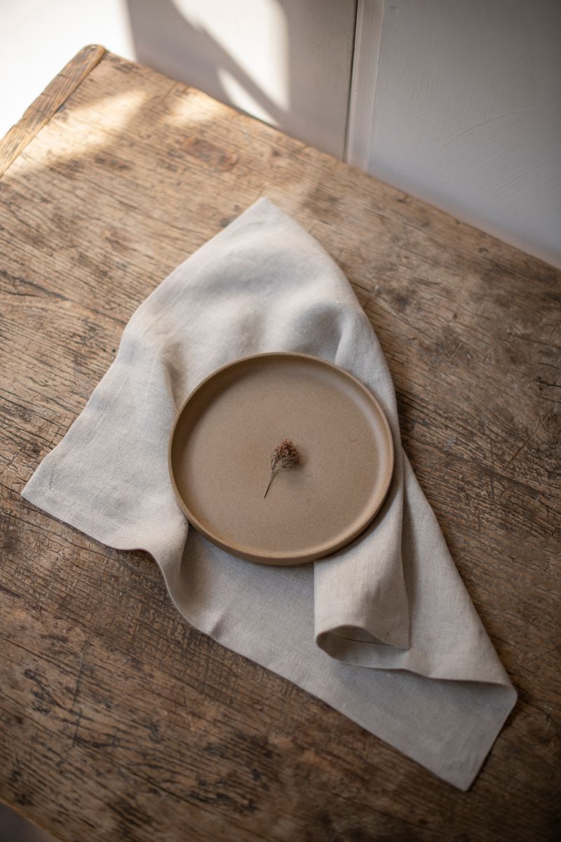 Linen Placemat by Timeless Linen set on wooden table with plate at Enter The Loft.