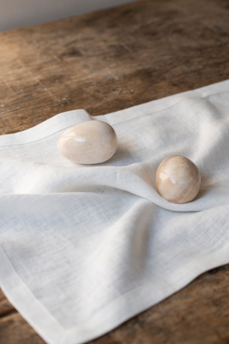 Timeless Linen Placemat set on wooden table with two eggs on it.