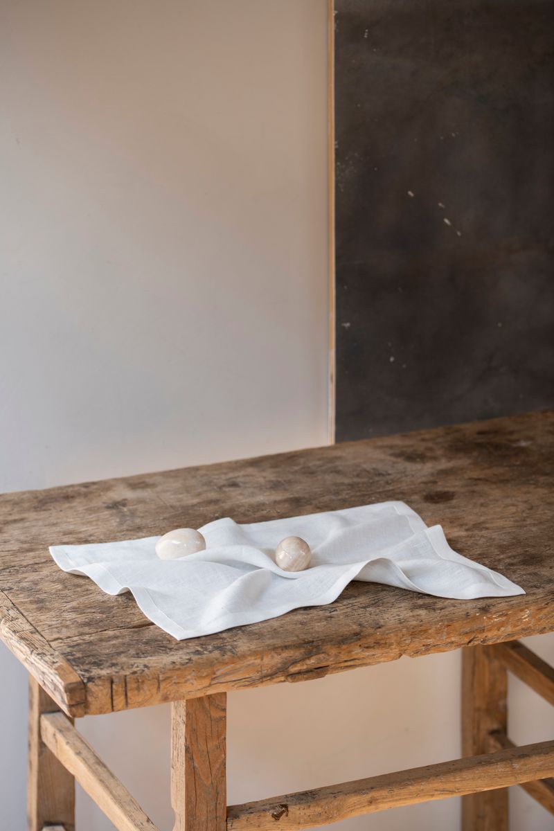 Linen Placemat by Timeless Linen set on wooden table with two eggs on it, at Enter The Loft.