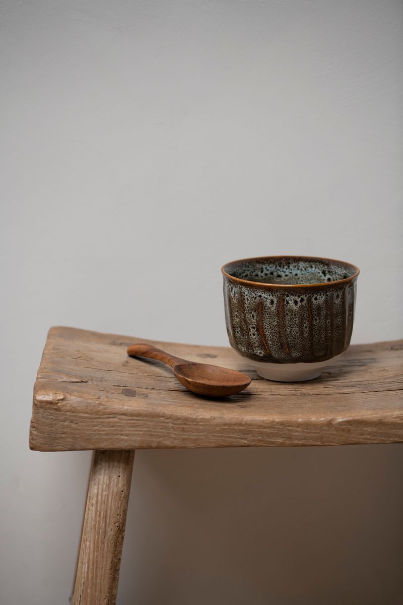 Jars Ceramistes Dashi Bowl Ecume and spoon on wooden stool.