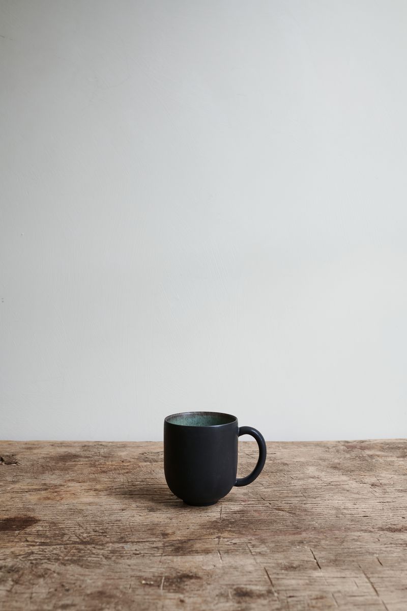 Samoa Mug by Jars Ceramistes on wooden table.