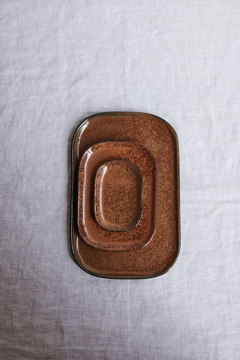 Top view of stack of Kobe Plates in Brown by Serax.