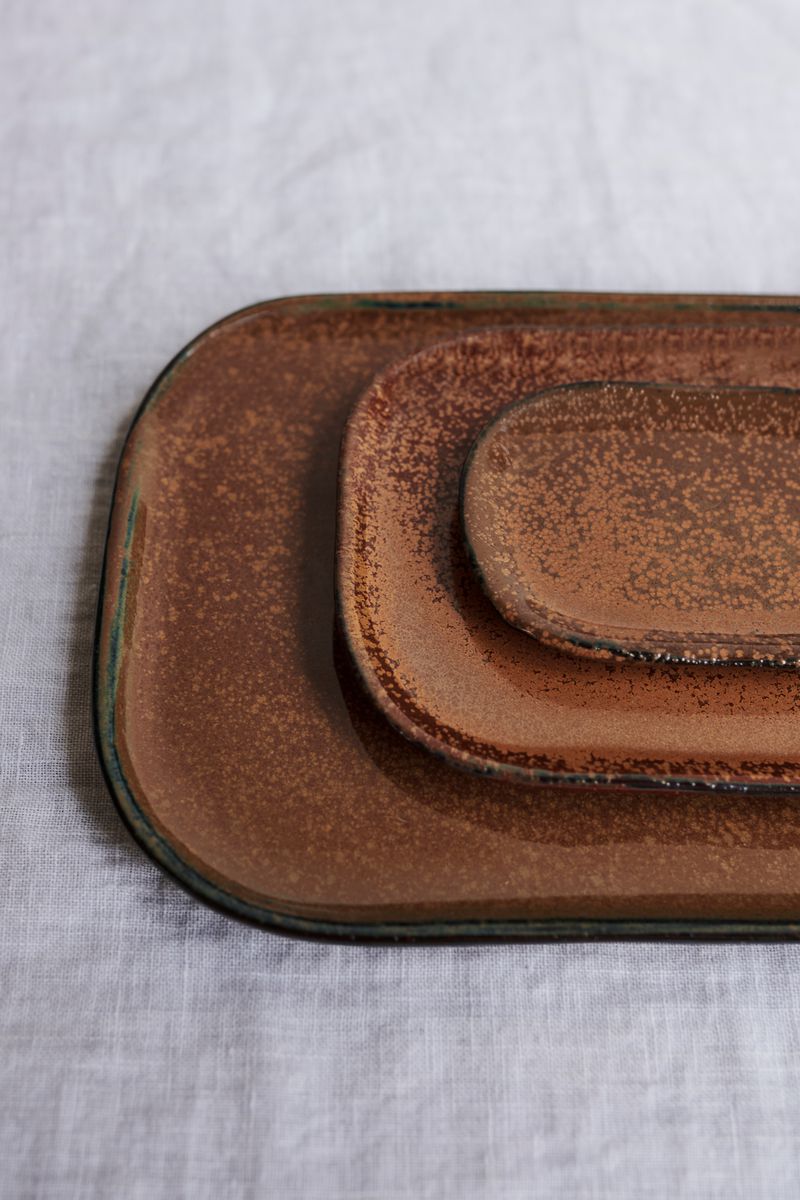 Close up of stack of Kobe Plates in Brown by Serax.