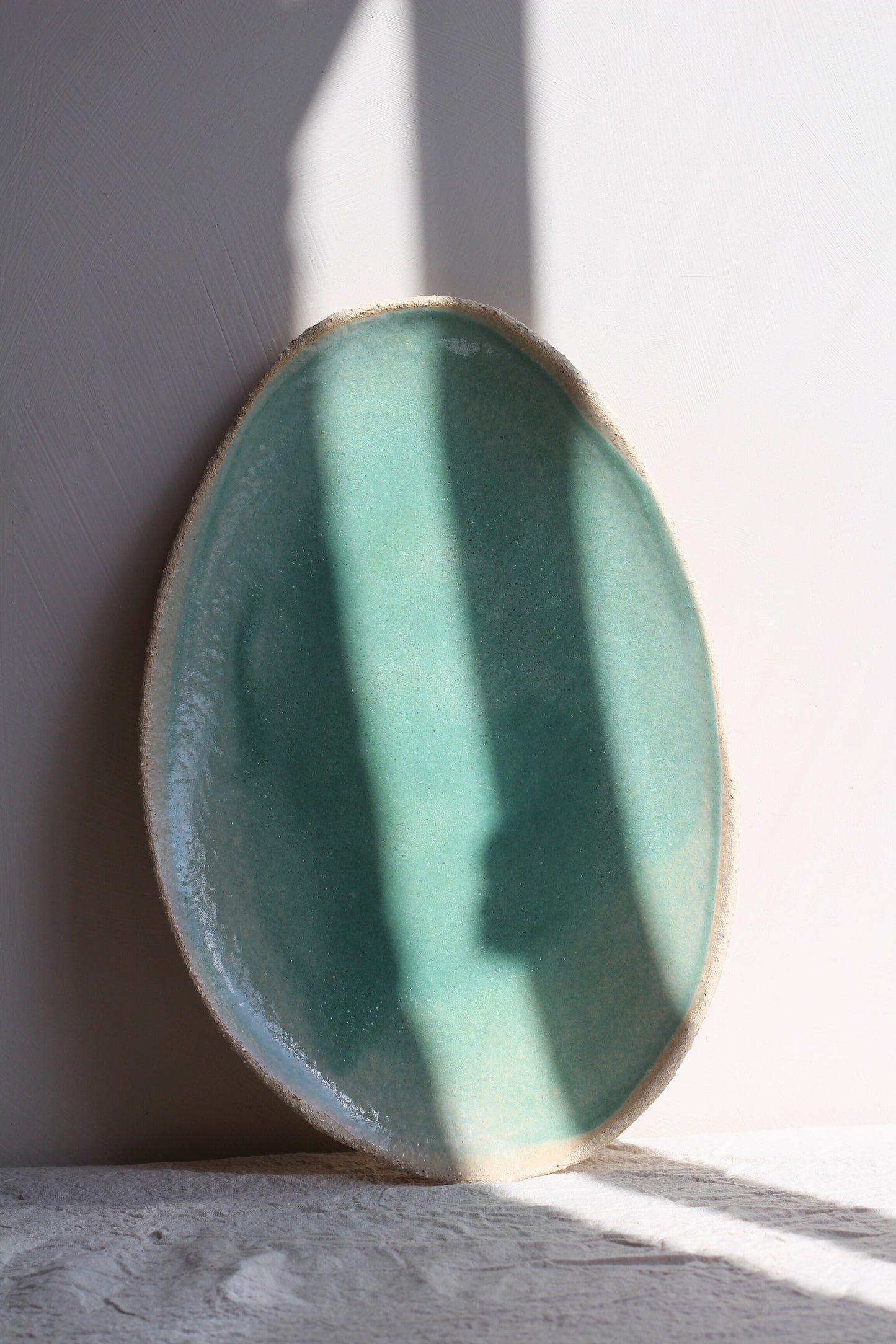 Close-up of the Plat Ovale Wabi Vert by Jars Ceramistes.