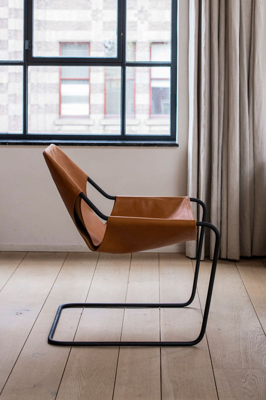 Side view of the leather Paulistano Chair with a Phosphate Black Frame.